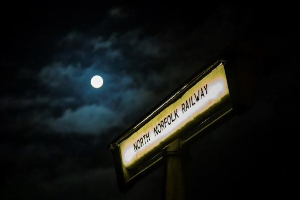 North Norfolk Railway sign against the night sky and moon