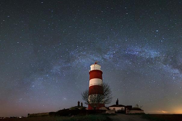 View of the Milky Way and Happisburgh Lightshouse with the night sky