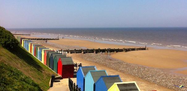 View of the beach huts and sand at Mundesley Beach