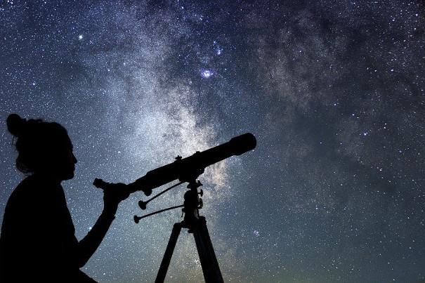 Star gazing with telescope against the night sky