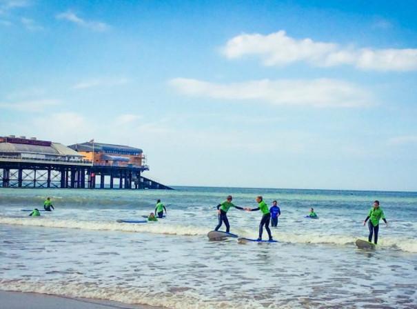 Surfers in the water near Cromer Pier