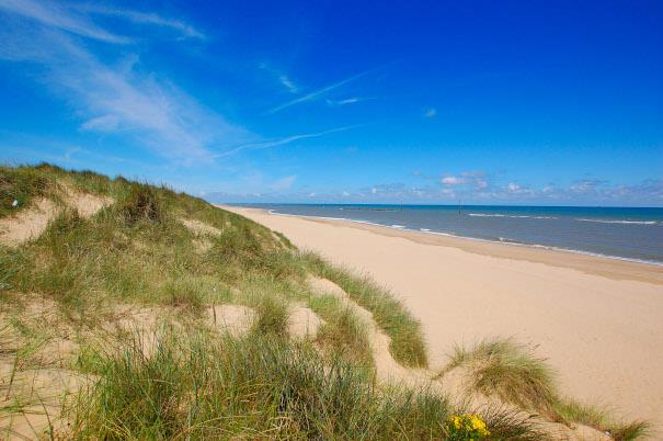 View of blue sky and beach at Waxham Beach